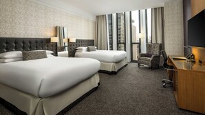 A hotel room with two beds, a desk, a chair, and a TV. - Hotel Chicago Downtown, Autograph Collection by Marriott (Chicago)