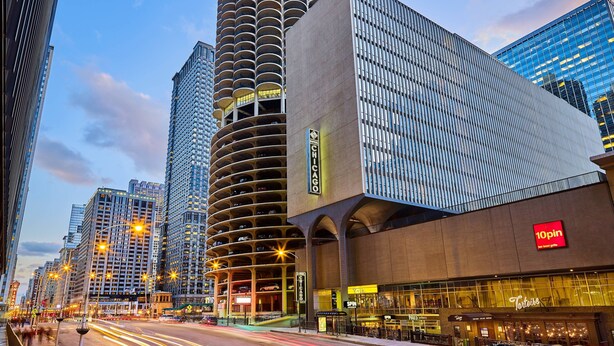 A modern urban building with a distinctive curved facade, a prominent '10pin' sign, and a 'Tertius' restaurant on the ground floor. - Hotel Chicago Downtown, Autograph Collection by Marriott (Chicago)