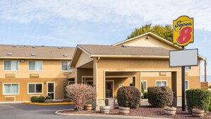 A Super 8 motel with a two-story building, multiple windows, and a covered entrance. - Super 8 by Wyndham LaGrande (La Grande)