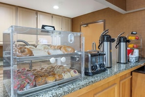 A breakfast buffet with bread, pastries, and a coffee station. - Best Western Circus City Inn (Peru)