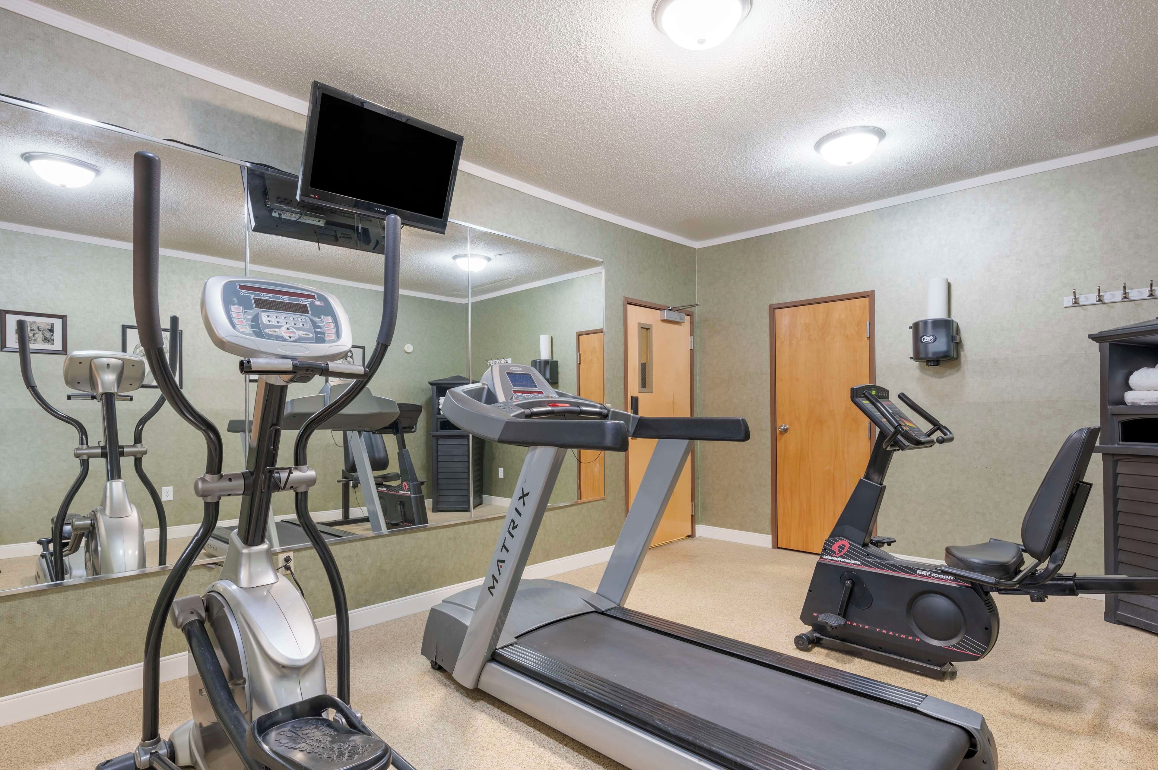 A fitness center with treadmills, an elliptical, and a stationary bike.