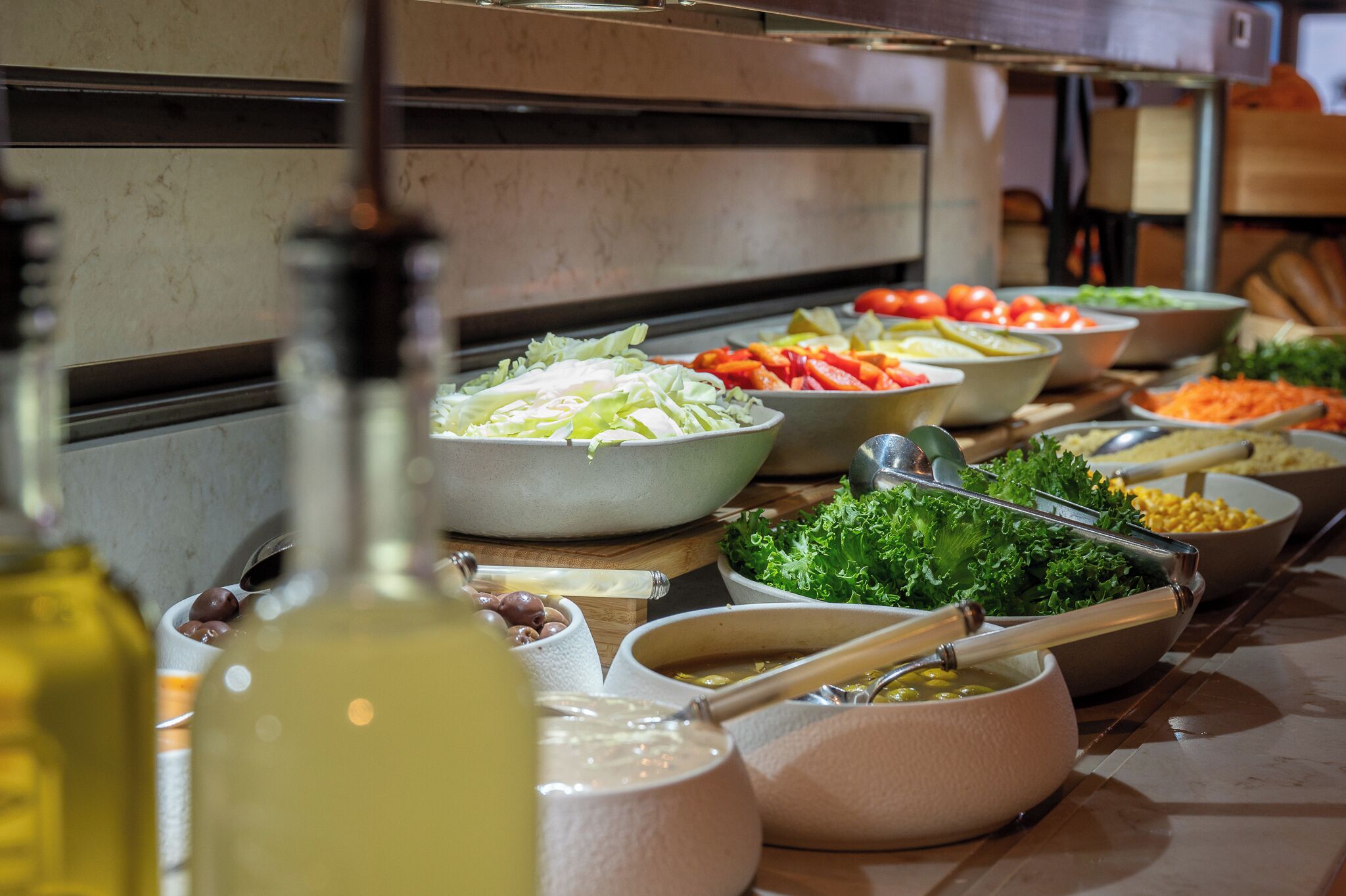 A buffet with various food items and condiments.