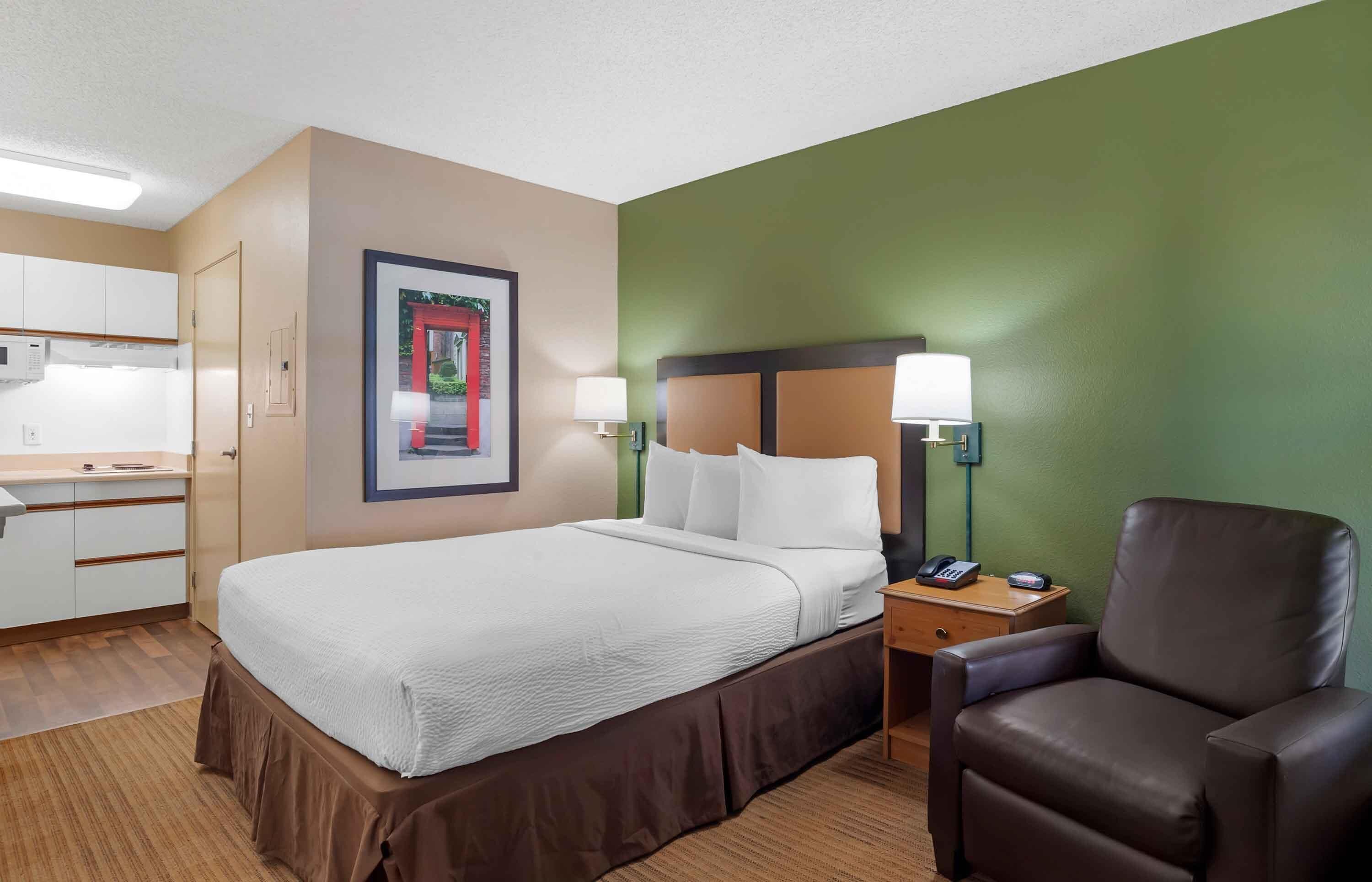 Premium bedding, desk, laptop workspace, iron/ironing board