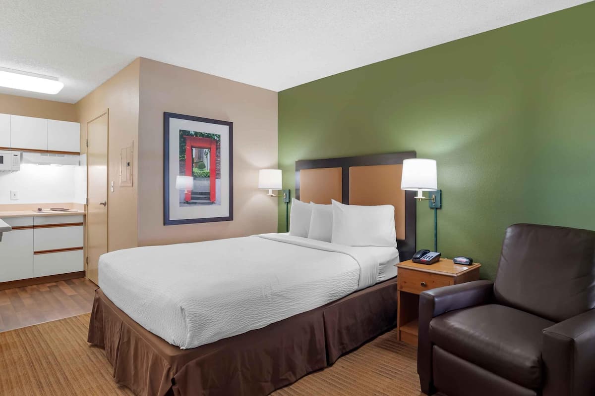 Premium bedding, desk, laptop workspace, iron/ironing board