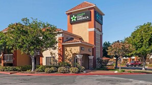 A Stay America hotel with a prominent sign, a lobby entrance, and a parking area. - Extended Stay America San Diego - Sorrento Mesa (San Diego)
