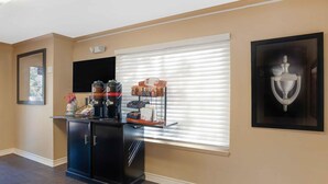 A room with a black cabinet, a coffee station, a framed picture, and a window with blinds. - Extended Stay America San Diego - Sorrento Mesa (San Diego)