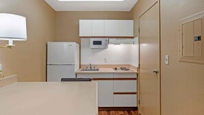 A compact kitchen with a refrigerator, microwave, and sink. - Extended Stay America San Diego - Sorrento Mesa (San Diego)