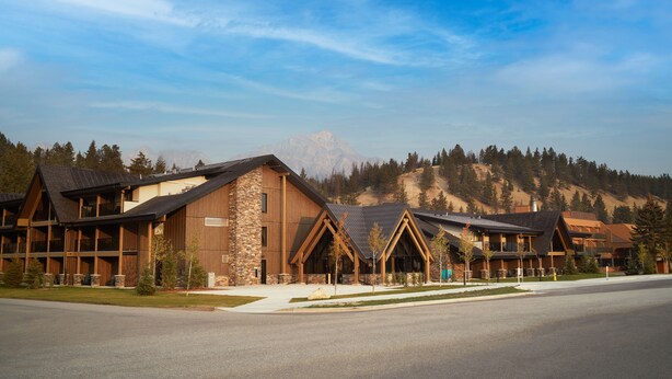 A lodge with a stone facade, wooden beams, and large windows.