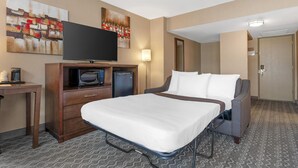 A hotel room with a bed, a desk with a television, a refrigerator, and a microwave. - Best Western Terrace Inn (Terrace)