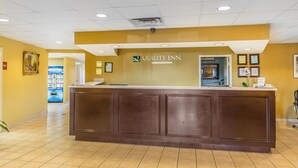 A reception desk with a sign reading "Quality Inn by Choice Hotels." - Quality Inn Calera I-65 exit 231 (Calera)