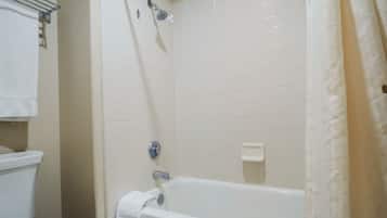 A bathroom with a bathtub, a shower, and a toilet.