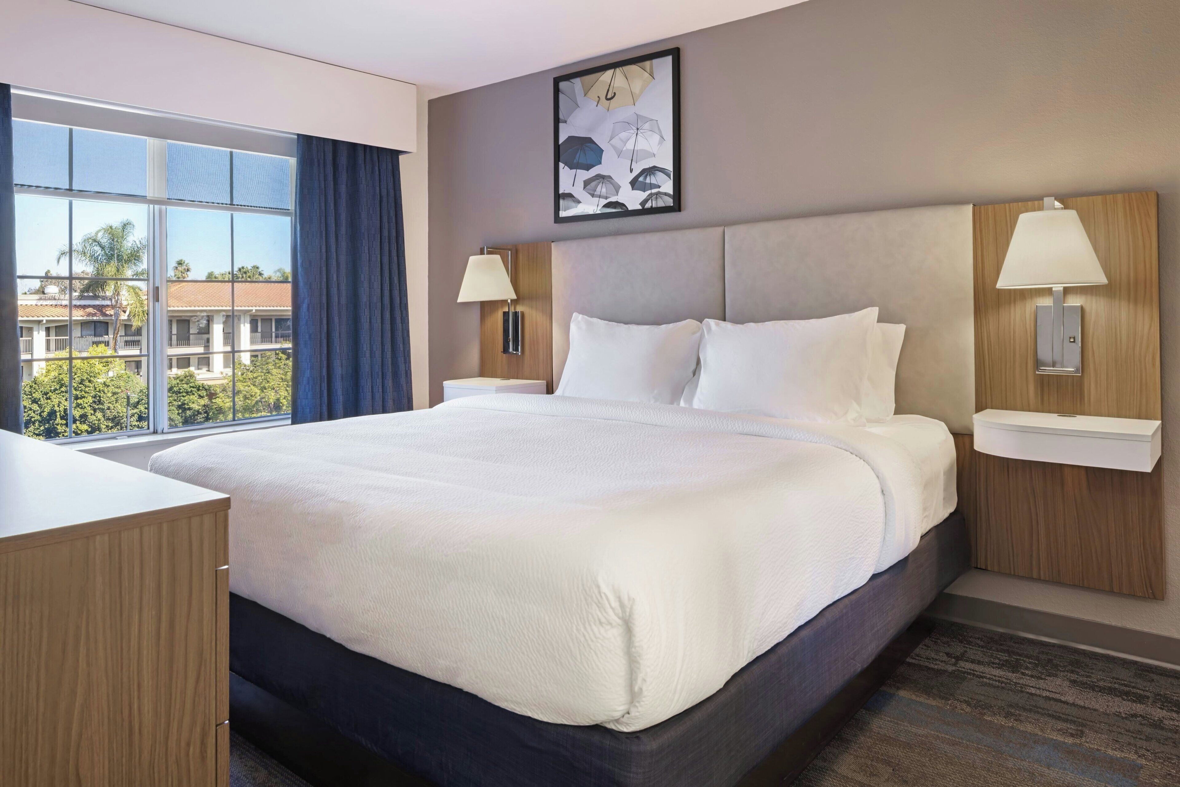 Premium bedding, desk, laptop workspace, blackout curtains