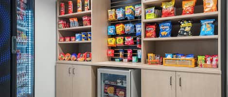 A snack and beverage vending area with various snack options and a refrigerated section.