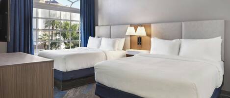 Premium bedding, desk, laptop workspace, blackout drapes