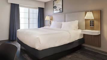 Premium bedding, desk, laptop workspace, blackout drapes