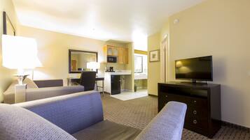 Suite, 1 cama King size | Área de sala de estar | Televisión de pantalla plana de 32 pulgadas con canales por cable