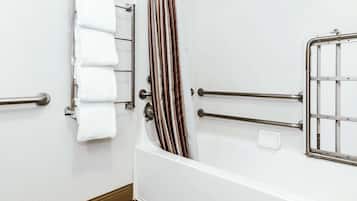A bathroom with a bathtub, a towel rack, and a shower curtain.