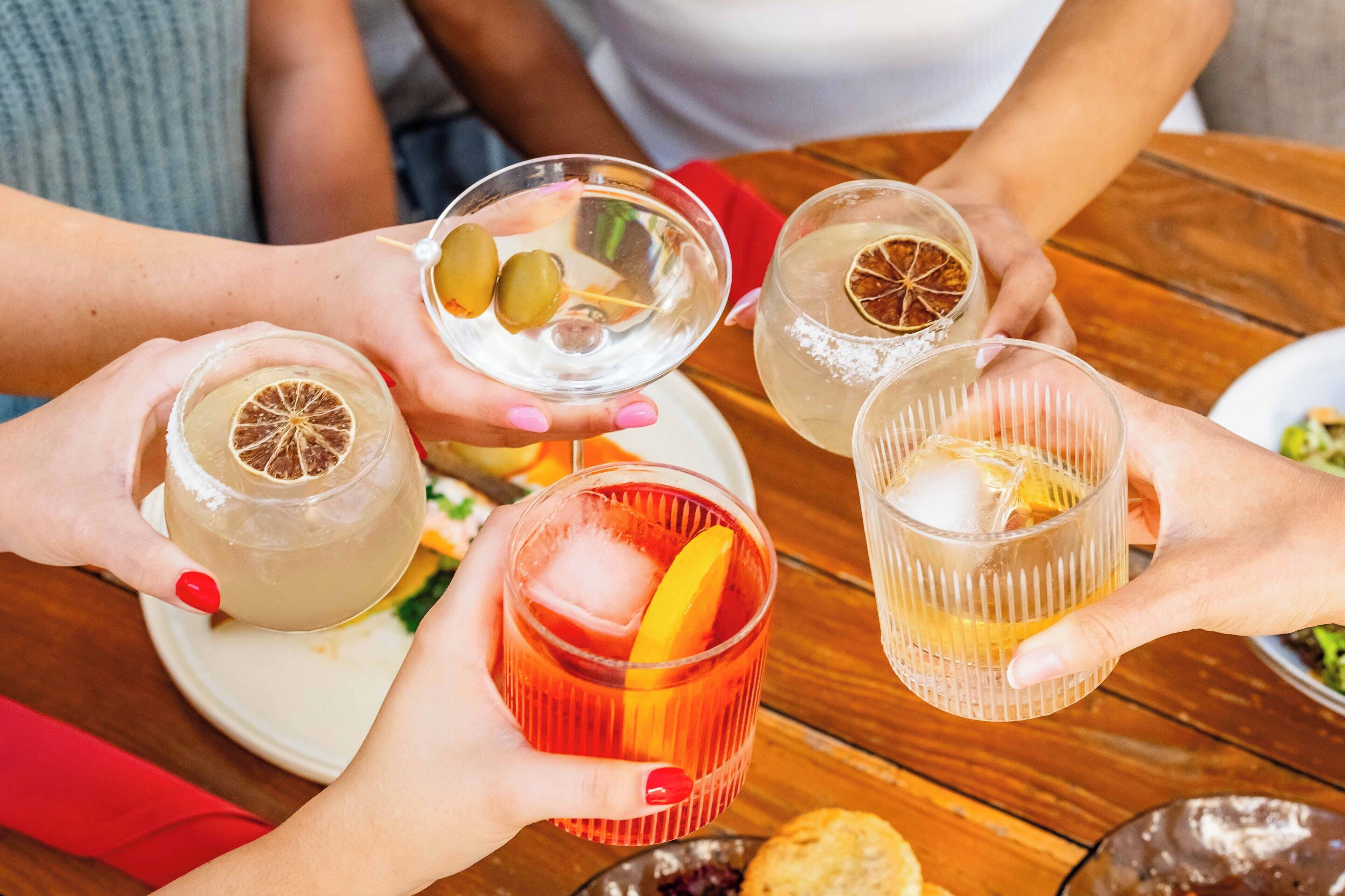 Un grupo de personas sosteniendo vasos con diferentes adornos.