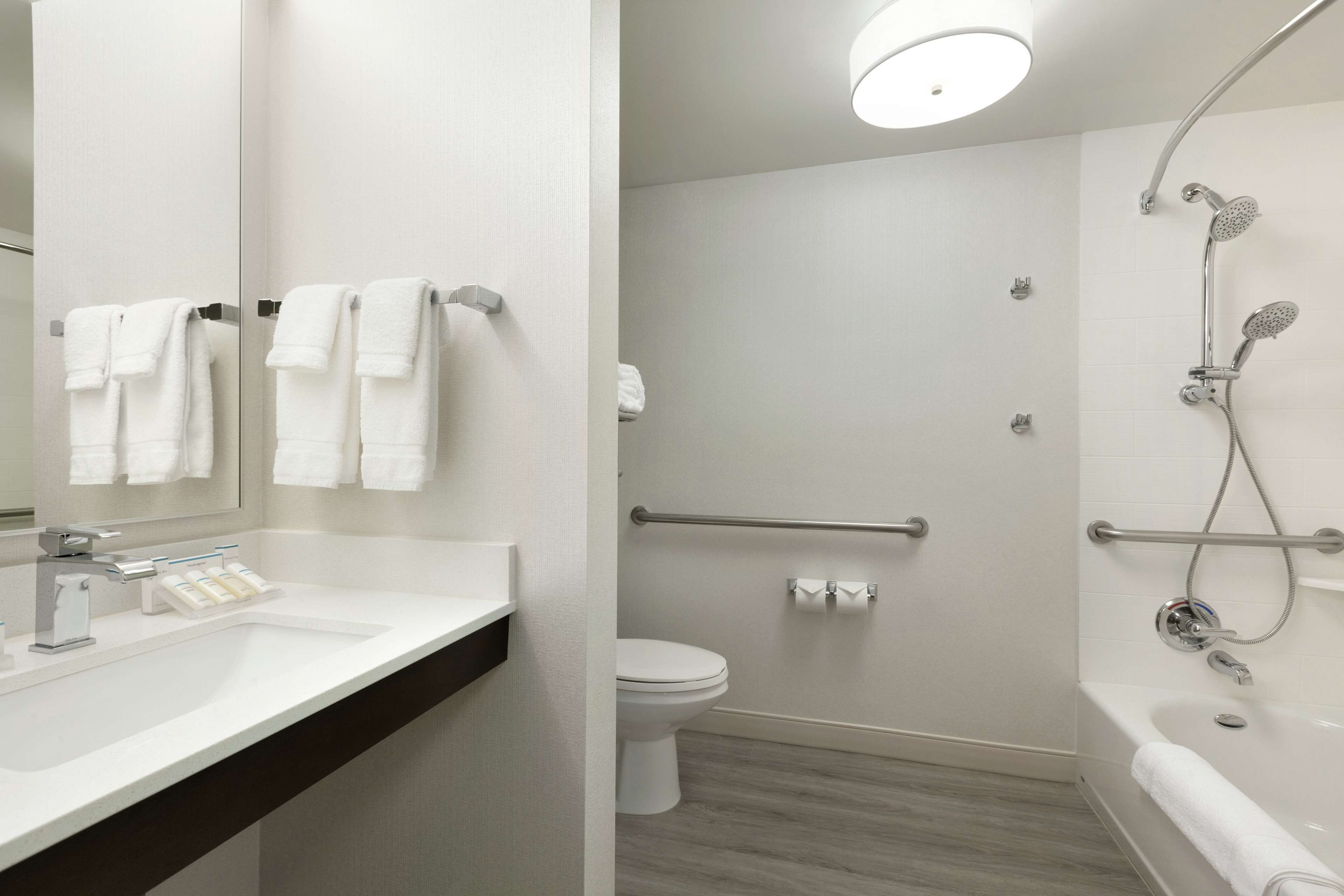 combined shower/bathtub, designer toiletries, hair dryer, towels