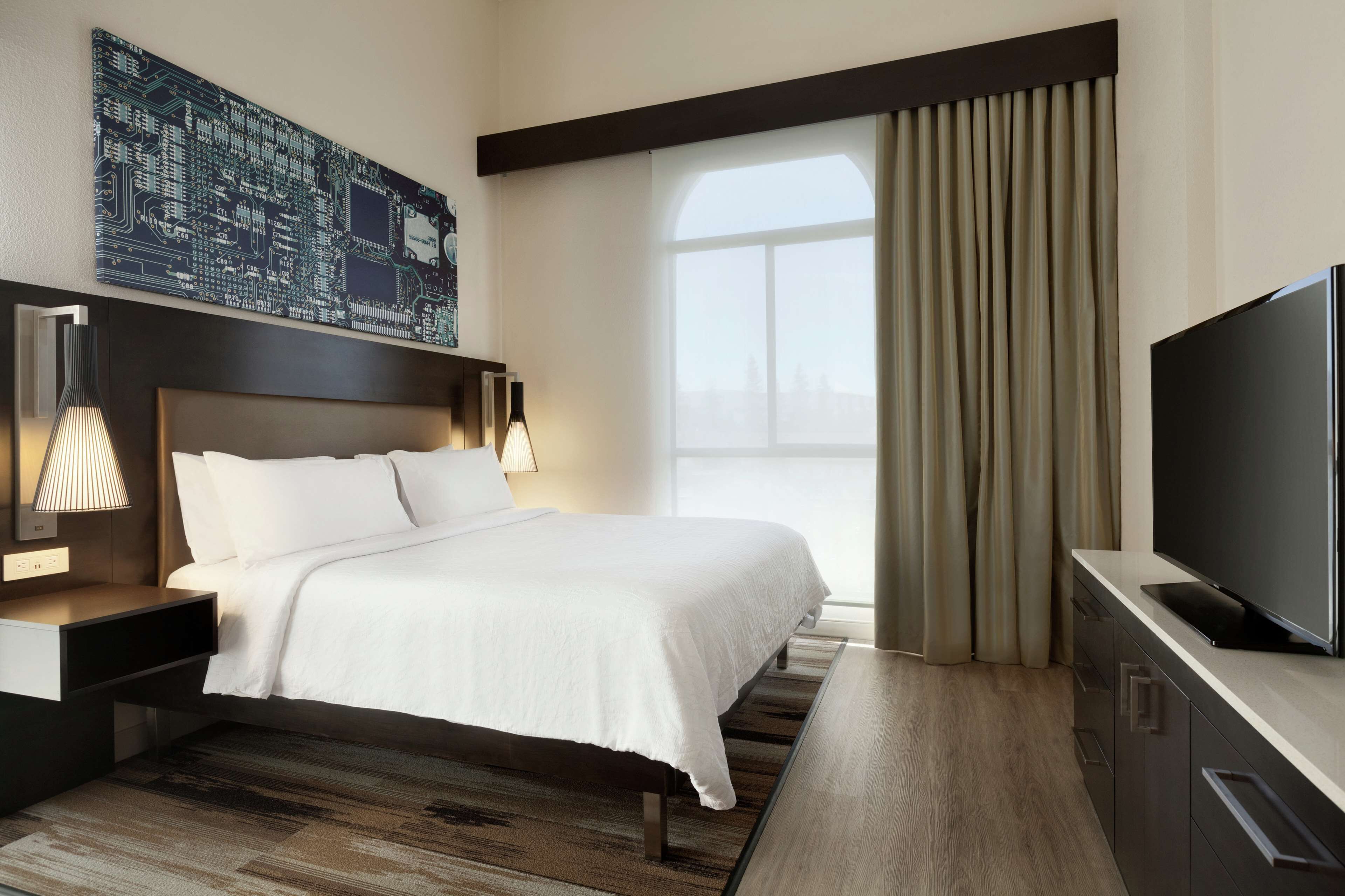 deluxe suite, 1 king bed | premium bedding, in-room safe, laptop workspace, iron/ironing board