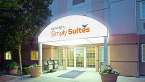 A hotel entrance with a sign reading "SONESTA Simply Suites".