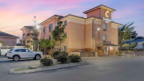A Comfort Inn hotel with a modern design, featuring a prominent 'Comfort Inn' sign on the building.