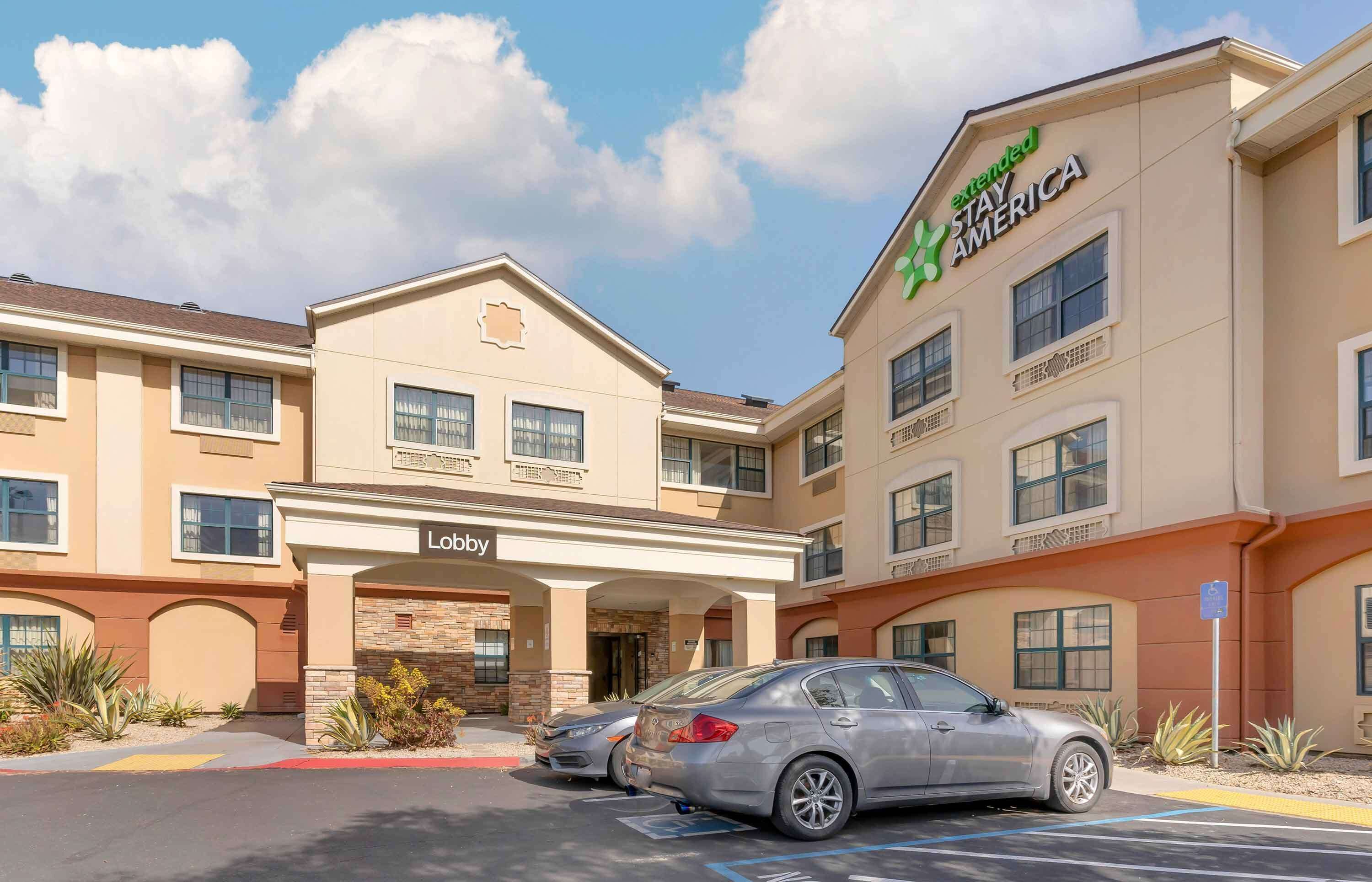 A hotel with a 'Lobby' entrance, multiple floors, and a 'Stay America' sign.
