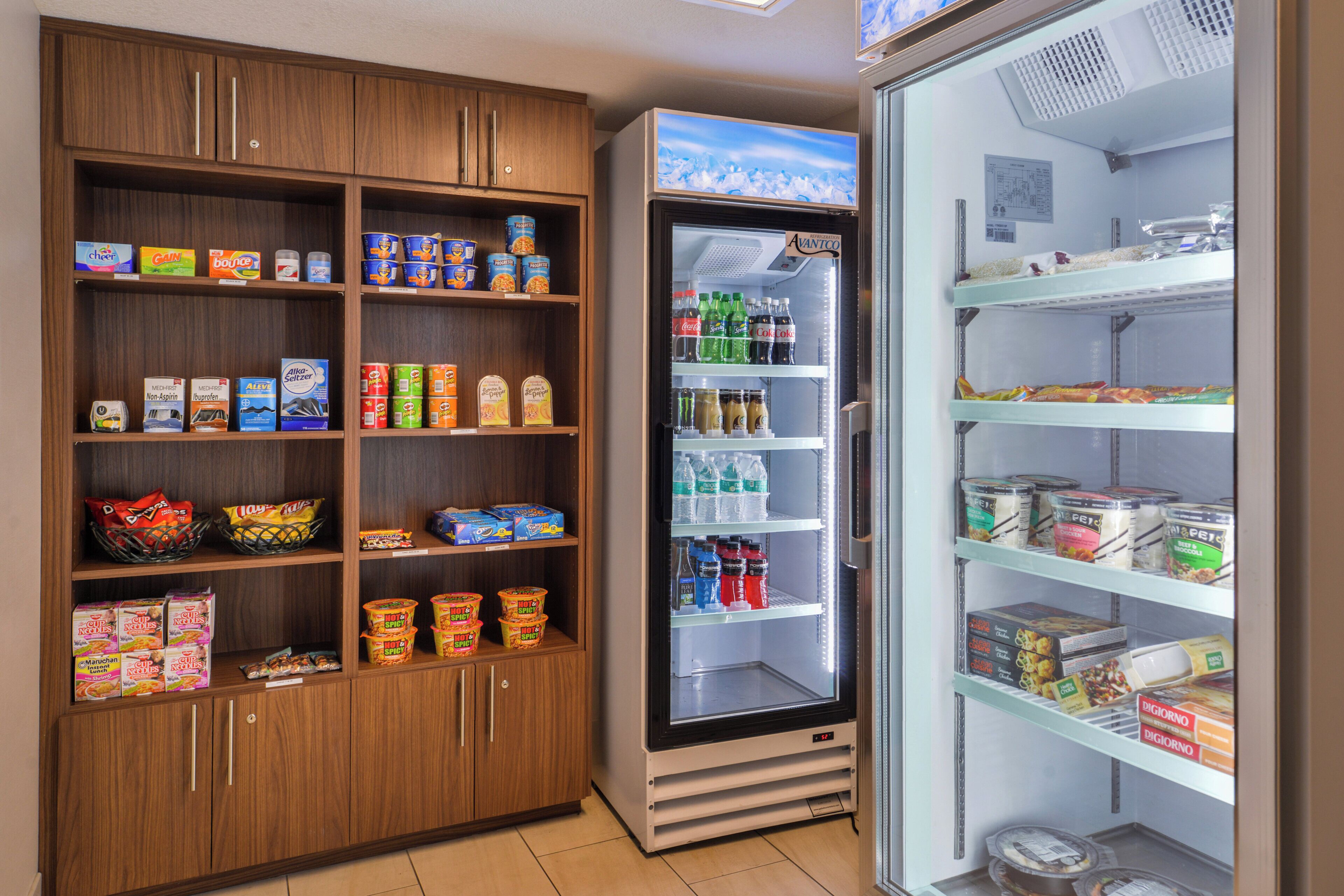 A refrigerated display case with various beverages and a freezer section with frozen food items.