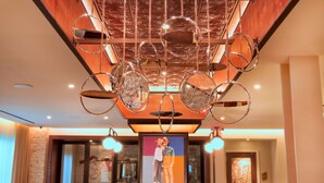 A ceiling with a unique circular mirror design and a framed artwork below. - Canopy by Hilton Washington Embassy Row (Washington)