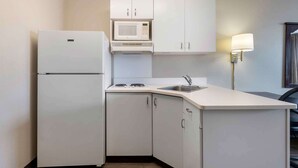 A compact kitchen with a refrigerator, microwave, and sink. - Extended Stay America Suites Chicago Romeoville Bollingbrook (Romeoville)