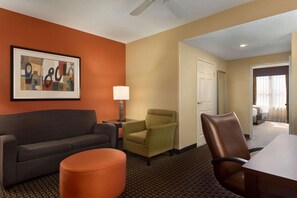 Relax in a spacious room with a comfortable sofa, armchair, and dining area, perfect for reading, dining, or working.