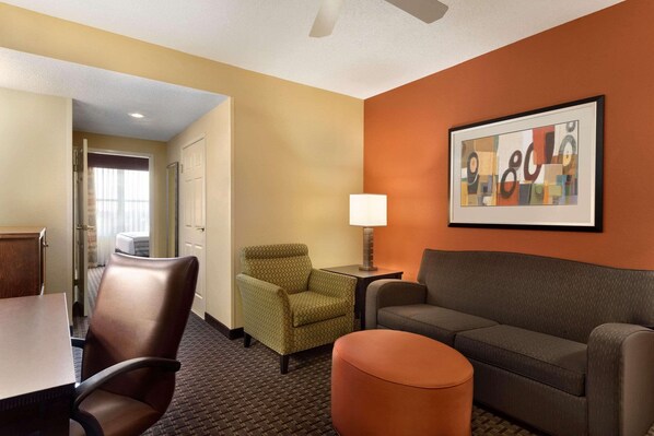 Relax in a spacious room with a dining area, seating area, and comfortable sofa.