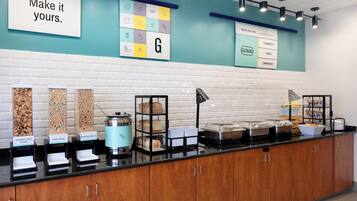 A breakfast buffet with various food options and a sign encouraging guests to 'Make it yours.'
