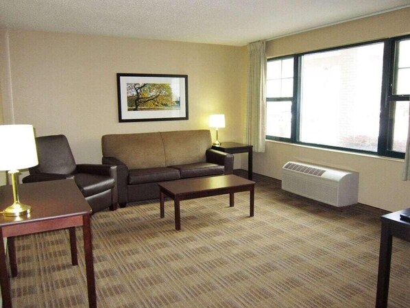 Relax in comfort with a sofa, coffee table, and artwork in this inviting space.