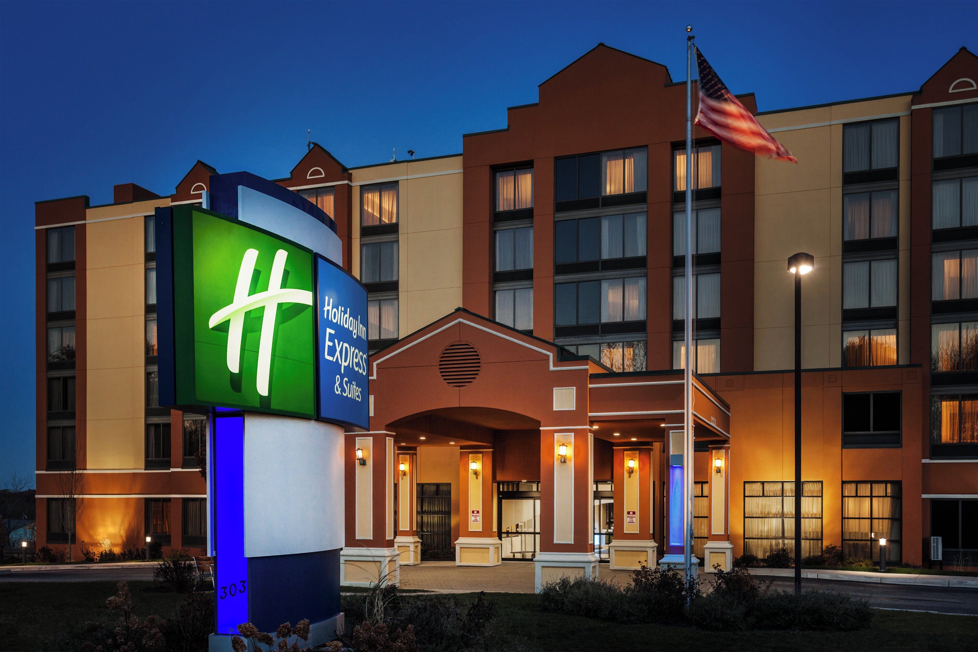 A hotel with a prominent sign, multiple floors, and an American flag.
