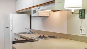 A compact kitchen with a refrigerator, a sink, and a stove. - Extended Stay America Suites Boston Marlborough (Marlborough)