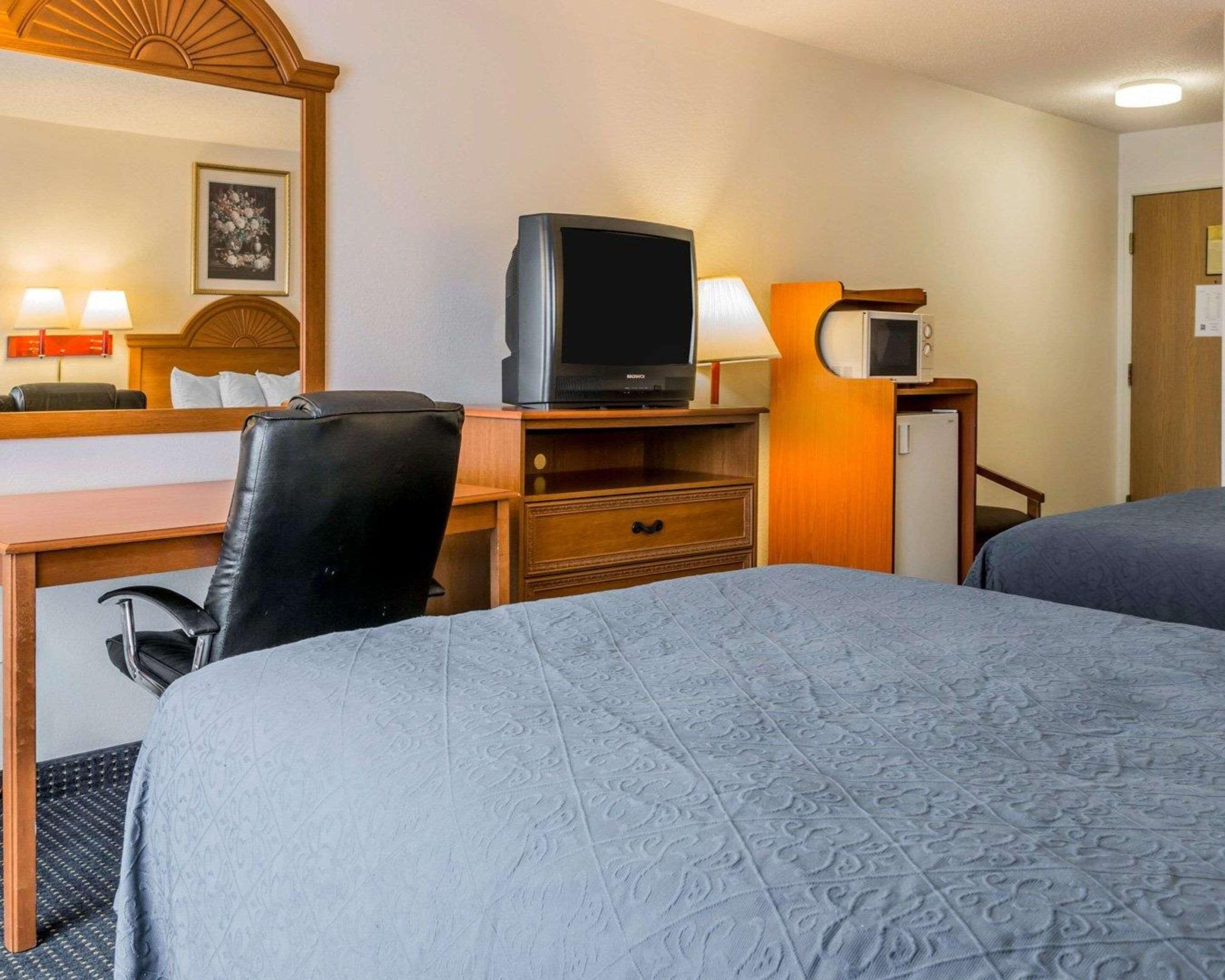 Premium bedding, desk, laptop workspace, iron/ironing board