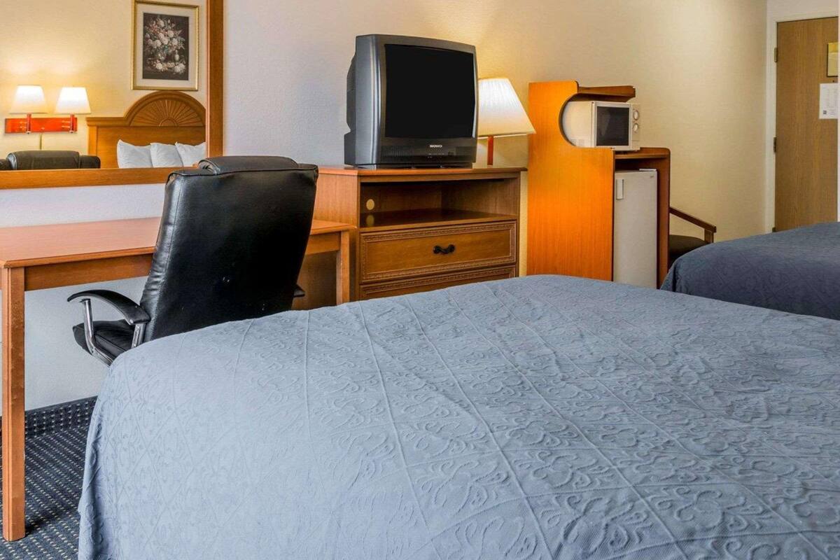 Premium bedding, desk, laptop workspace, iron/ironing board