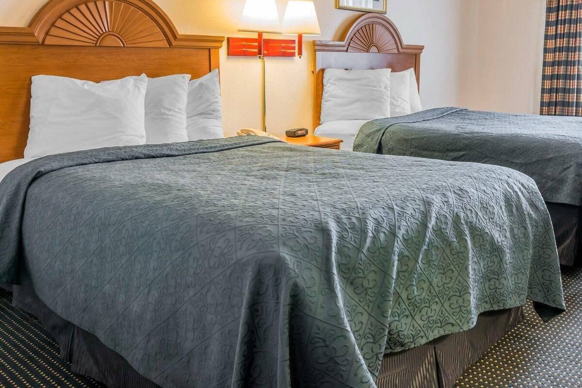 Premium bedding, desk, laptop workspace, iron/ironing board