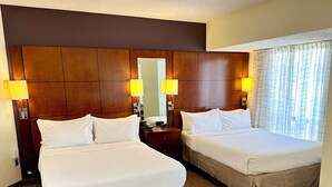 A hotel room with two beds, wooden headboard, bedside lamps, and a patterned carpet. - Residence Inn By Marriott Minneapolis Downtown (Minneapolis)