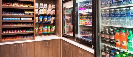 A refrigerated beverage display with various drinks and snacks.