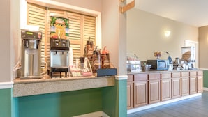 A breakfast bar with coffee machines, a microwave, and a coffee station.