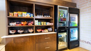 A snack bar with shelves of chips, candies, and bottled water. - Fairfield Inn & Suites by Marriott St. Louis Chesterfield (Chesterfield)
