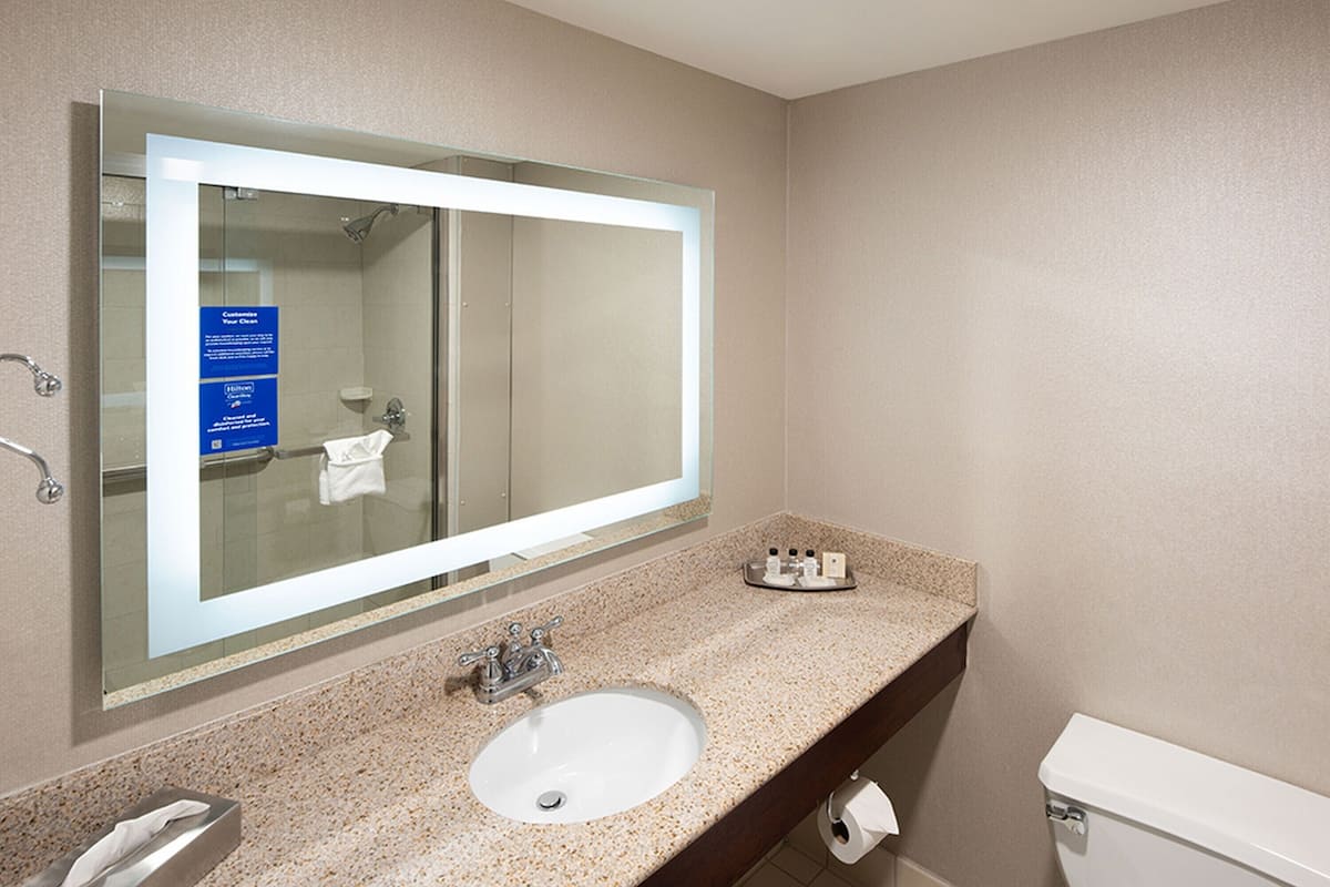 designer toiletries, hair dryer, towels, soap