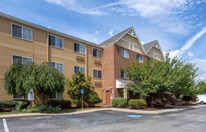 Hotel features a modern architectural design with a gabled roof and well-manicured landscaping.