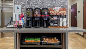 A self-service beverage station with hot and cold water dispensers, a coffee machine, and a selection of snacks and beverages. - Extended Stay America Suites Charlotte Pineville Park Rd (Pineville)