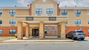 A hotel entrance with a lobby sign, a parking area, and a brick facade. - Extended Stay America Suites Charlotte Pineville Park Rd (Pineville)