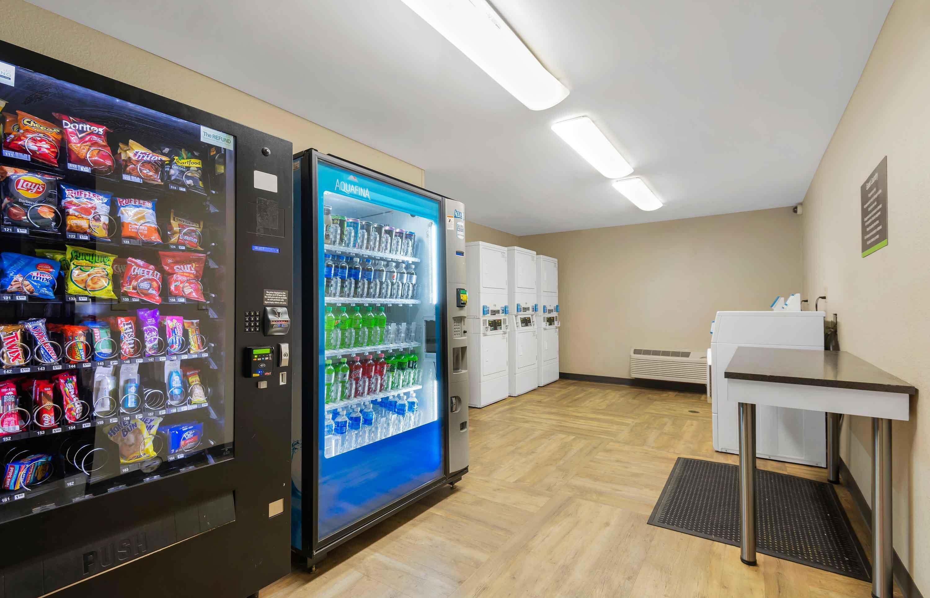 A vending area with snack and water options, a small table, and a restroom in the background.