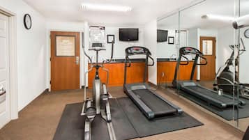 A fitness room with treadmills, an elliptical, and a stationary bike.