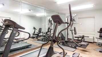 A gym with treadmills, elliptical machines, and weight equipment.